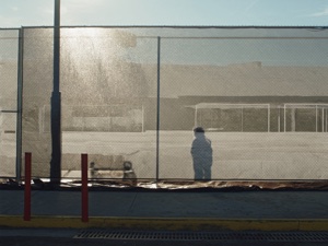 Custom mesh banner on construction site fence — wind-resistant large format print