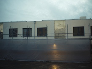 Custom mesh banner wrap on building scaffolding — large format print installation