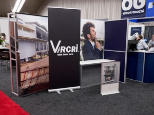 Retractable banner stands at trade show booth — portable custom display printing